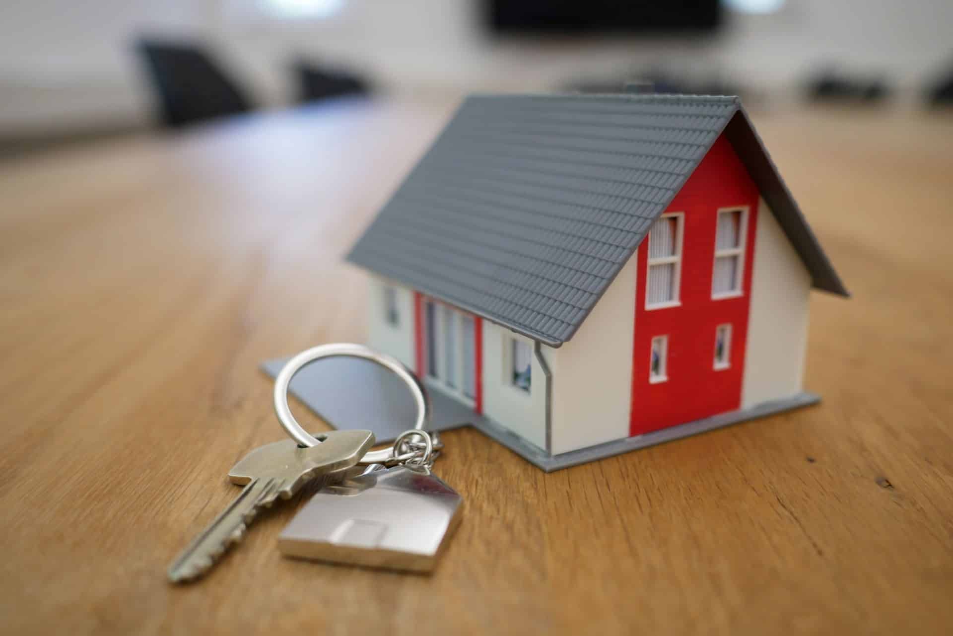 Foto von Spielzeughaus mit Schlüssel als Symbol für Immobilienerwerb durch Ausländer